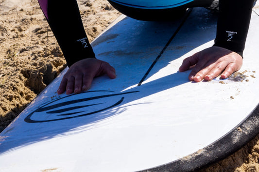Surfista realizando ejercicios para mejorar su surf antes de entrar al agua