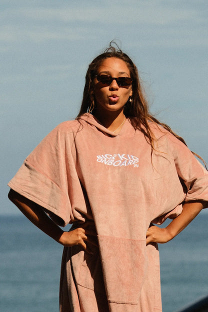 Guida con el poncho rosa en la playa de madeira