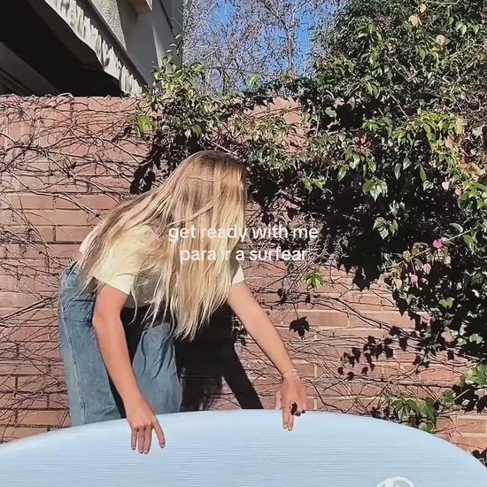 Preparándose para surfear con una tabla shortboard de corcho azul. 